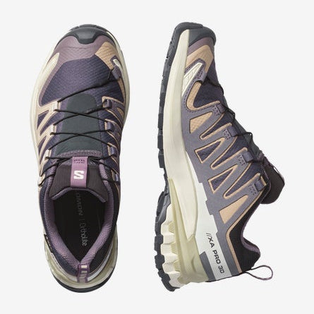 Pair of purple and gray athletic shoes on a white background