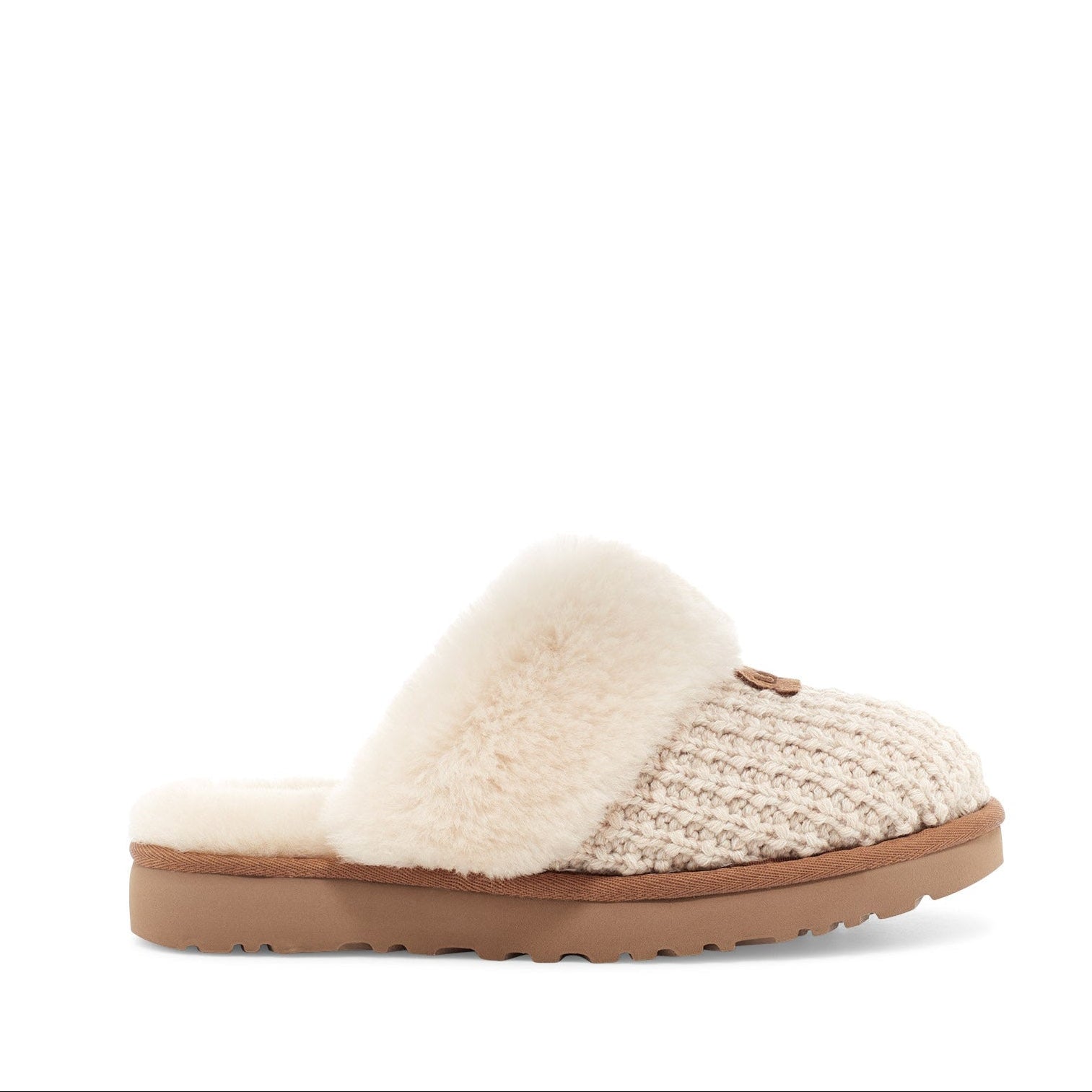 Beige slipper with brown sole on a white background