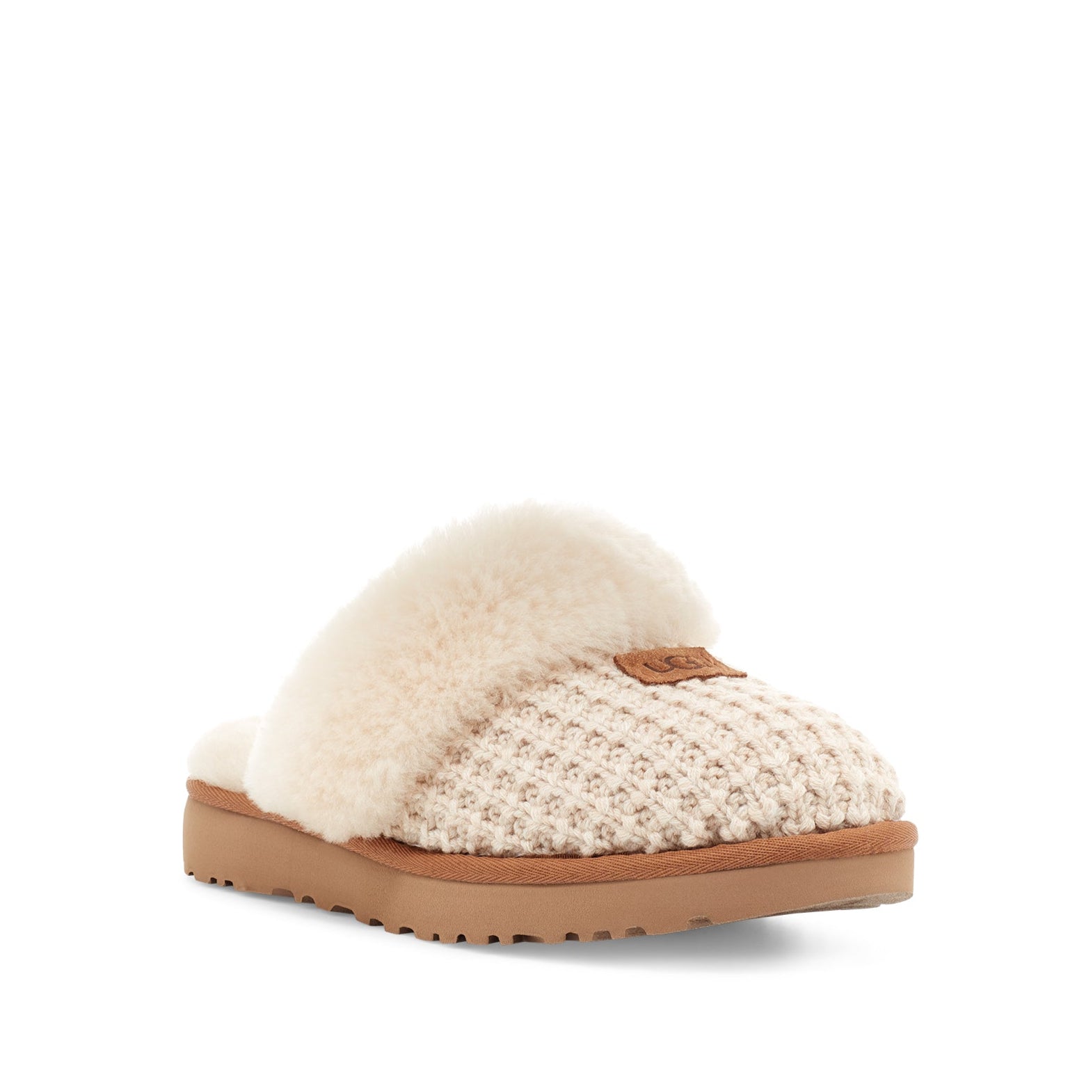Slipper with white fur lining and brown sole on a white background