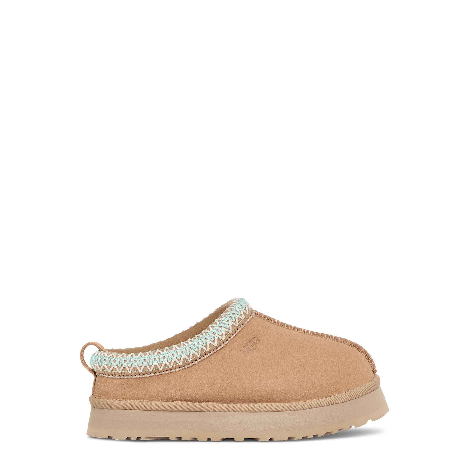 Tan slipper with white trim on a white background