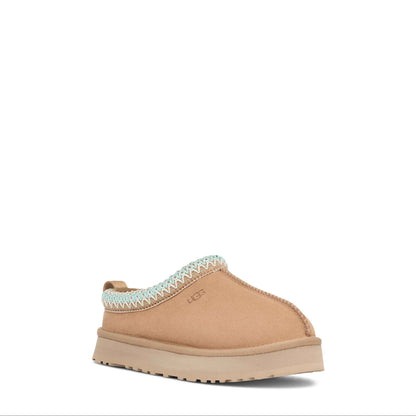 Tan slipper with white trim on a white background