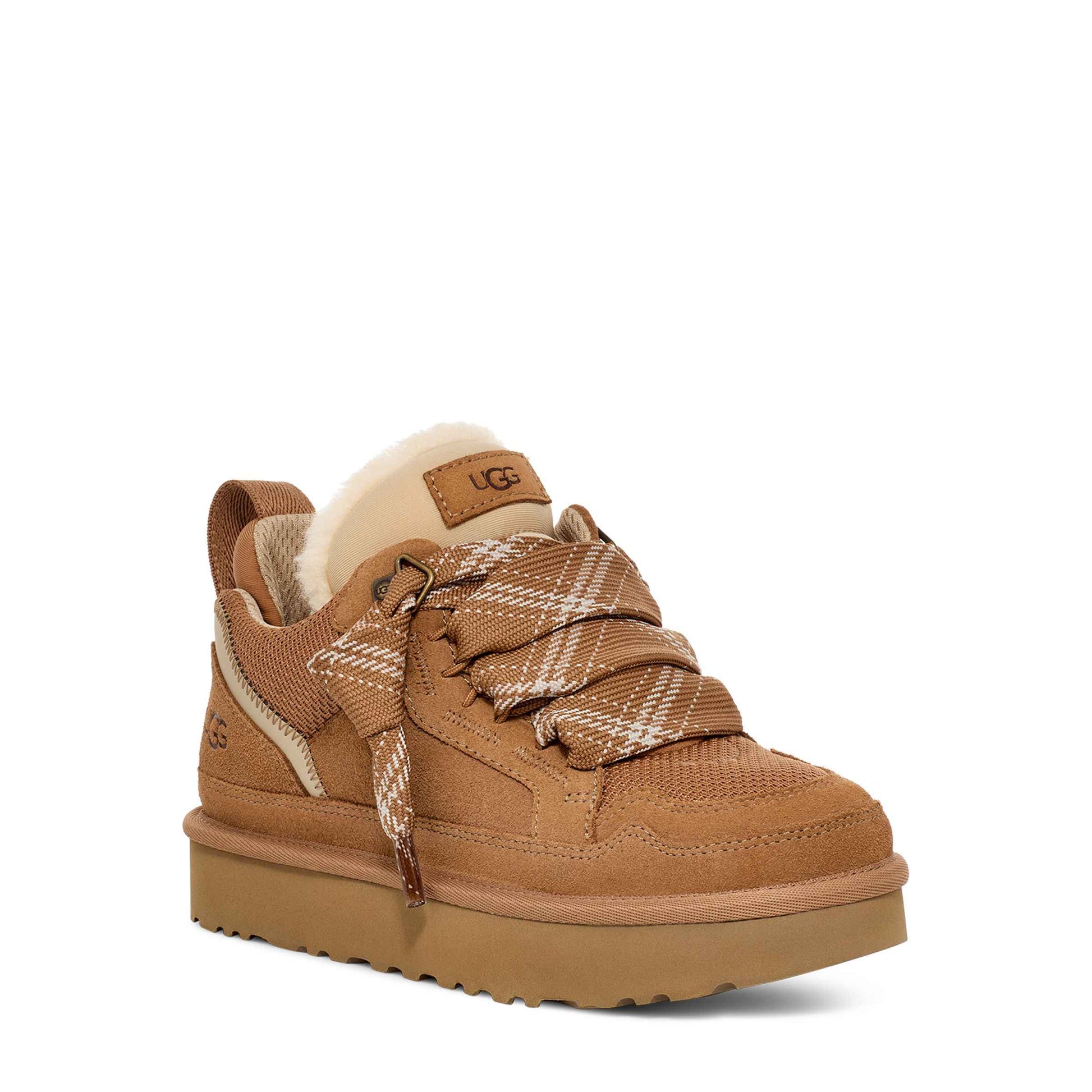 Brown sneaker with platform sole on a white background