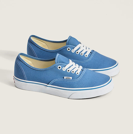 Pair of vans sneakers with white soles on a light gray background
