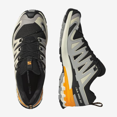 Black and gray athletic shoes with orange accents on a white background